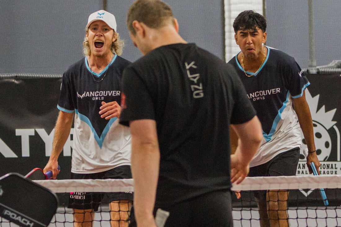 Two Vancouver Owls pickleball players reacting intensely during a match against an opponent in black shirt.