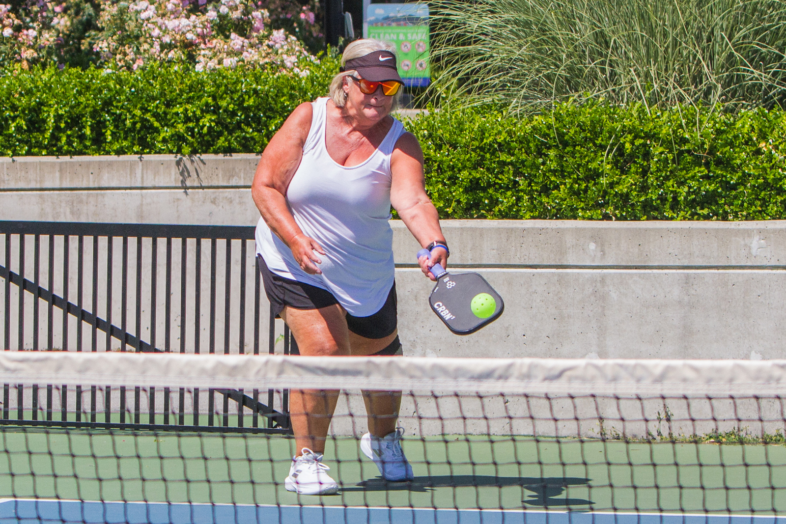 Pickleball player returning a shot during a BC tournament.